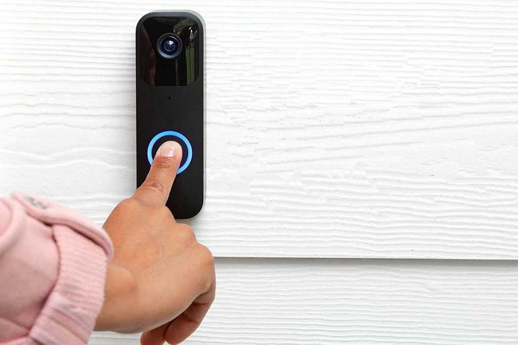 Finger pressing button on Blink Video Doorbell